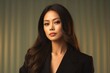 © Leon Waltz - medium shot portrait of a Filipino woman in her 30s wearing a classic blazer against an abstract background