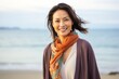 © Anne-Marie Albrecht - medium shot portrait of a happy Japanese woman in her 30s wearing a foulard against a beach background