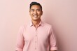 © Leon Waltz - portrait of a Filipino man in his 40s wearing a chic cardigan against a pastel or soft colors background