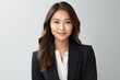 © Leon Waltz - portrait of a Filipino woman in her 30s wearing a sleek suit against a white background