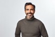 © Anne-Marie Albrecht - medium shot portrait of a Mexican man in his 40s wearing a cozy sweater against a white background