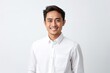 medium shot portrait of a confident Filipino man in his 30s wearing a chic cardigan against a white background