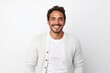 © Leon Waltz - portrait of a Mexican man in his 30s wearing a chic cardigan against a white background