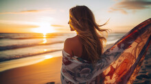 Young Beautiful Woman Looking At Sunset On The Beach With A Shawl On Her Shoulders On A Fresh Evening