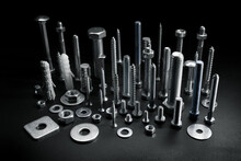 Group Of Various Screws, Bolts And Fasteners On Black Background