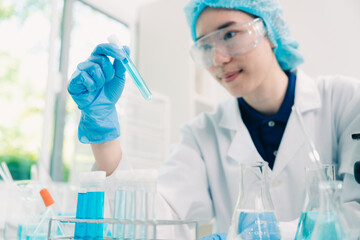 Wall Mural - Scientist analyzing and dropping a sample into a glassware, Medicine science experiments containing chemical liquid in laboratory on glassware, innovative and technology.