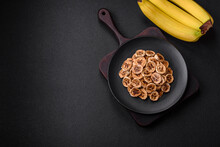 Round Slices Of Sweet Banana On A Dark Concrete Background