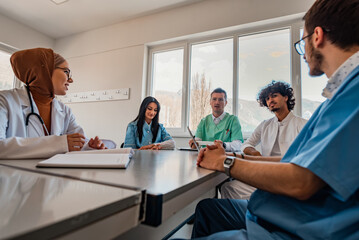 Wall Mural - A medical team of doctors discussing at a meeting in the conference room.