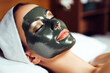 Beautiful Woman Lying On A Bed In A Beauty Salon With A Black Charcoal Peel Off Mask On Her Face. Ai Generated
