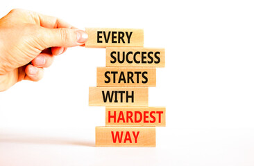 Wall Mural - Success symbol. Concept words Every success starts with hardest way on wooden block. Beautiful white table white background. Businessman hand. Business success and hardest way concept. Copy space.