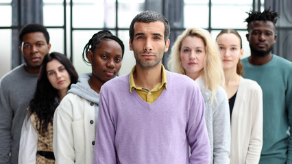 Wall Mural - Group of business people standing at the window of a modern office