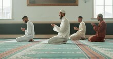 Muslim, Religion And People Praying In Mosque For Community, Ritual And Learning Quran. Holy Temple, Prayer And Men In Religious Building For Ramadan Kareem, Eid Mubarak And Worship Allah On Carpet
