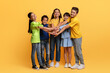 © Prostock-studio - Happy multiracial school aged kids holding hands top each other