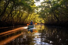 A Man Is Seen Paddling A Canoe Down A River. This Versatile Image Can Be Used To Depict Outdoor Activities, Adventure, Travel, Leisure, And Nature Exploration.