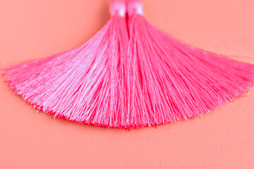 Wall Mural - Pink tassel on coral background
