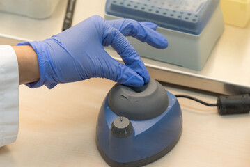 Research scientist using micro pipette for test analysis in modern genetic laboratory