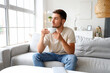 © Pixel-Shot - Young man drinking tea on his day off at home