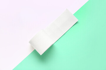 Roll of toilet paper on colorful background