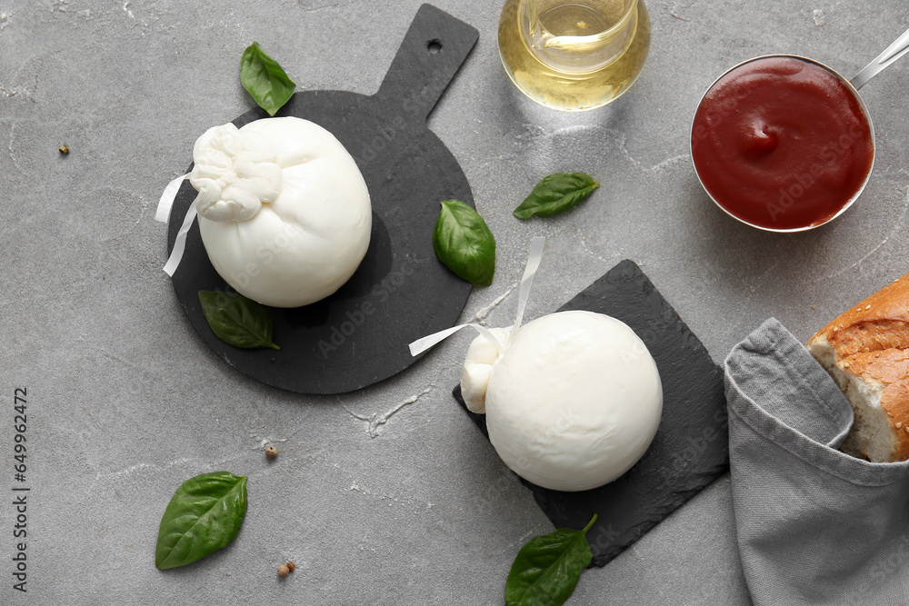 Boards with tasty Burrata cheese on grey background