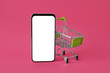Leinwandbild Motiv Shopping cart and mobile phone on pink background