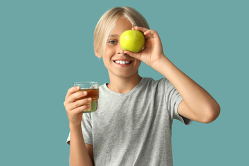 Sticker - Little boy with glass of juice and apple on blue background