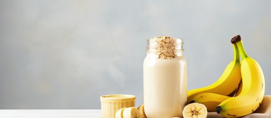 Poster - Healthy vegan smoothie with banana and oatmeal in a jar on a light background