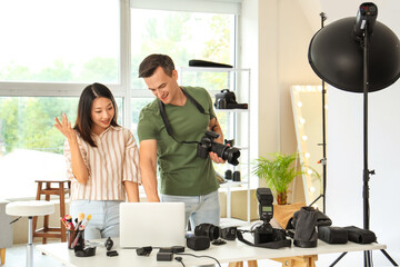 Wall Mural - Male photographer and his assistant working in studio