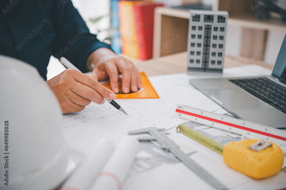 engineer working in office with blueprints, inspection in workplace for ...