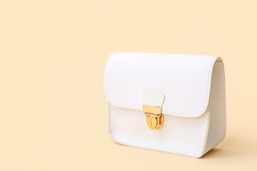 Sticker - Stylish white bag on beige background