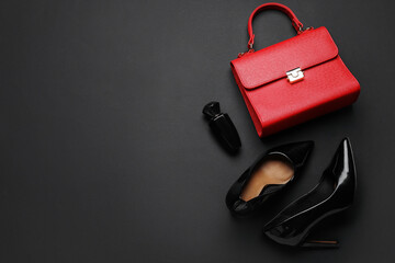 Poster - Stylish black high heels with handbag and perfume on color background