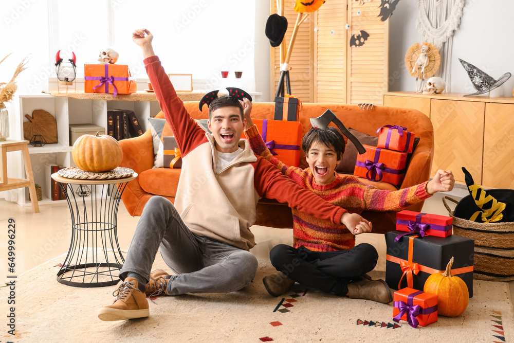 Happy little boy with his father dressed for Halloween at home