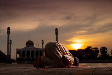 Wall Mural - A little Asian Muslim boy is praying with peace in the beautiful mosque, giving a powerful atmosphere of faith, with copy space, islam concept.