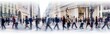 Walking people blur. Lots of people walk in the City of London. Wide panoramic view of people crossing the road. 