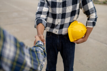 Poster - Architect and engineer shaking hands at job site, the project commissioned by the client, and the custom design before delivery. Interior design and decoration ideas.