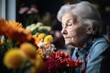 © altitudevisual - shot of a senior woman looking thoughtful during a flower arranging workshop at a nursery