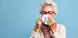 A beautiful senior woman manages her runny nose with elegance, using a pristine white tissue.