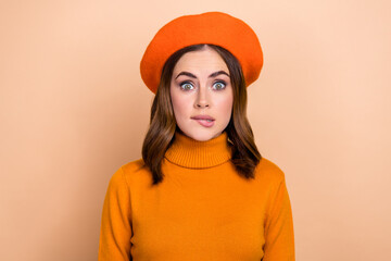 Wall Mural - Photo of gorgeous impressed confused girl biting lips isolated on pastel beige color background