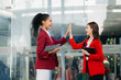 © Nuttapong punna - Business Show me the joy hi five hands With women executives celebrating the success in city Outside Office .