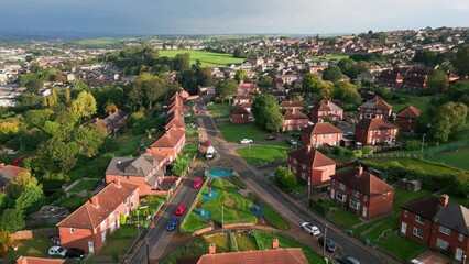 Wall Mural - Yorkshire's housing district: Red-brick council housing, aerial view, sunny morning, residents going about their day.