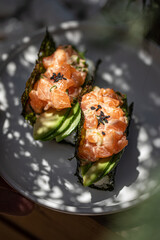 Wall Mural - Portion of appetizing trendy sushi hand rolls with salmon