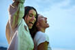 © CarlosBarquero - Two excited young Caucasian friends hanging out dancing party in evening having fun at weekend. Happy beautiful people enjoying leisure time outdoor. Attractive gen z women celebrating summer night.