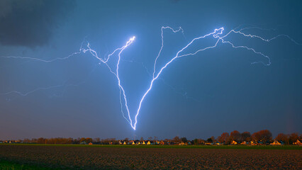 Wall Mural - Branched lightning bolt moving upwards, an example of positive lightning