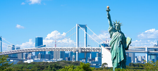 Tokyo, Japan. Odaiba, a popular tourist destination. A replica of the Statue of Liberty and the cityscape of Tokyo.