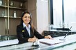 Beautiful asian hotel receptionist in  uniforms at desk in lobby Friendly and welcome staff in hotel reception counter.