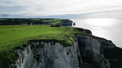 Wall Mural - Aerial View of the cliffs of Étretat on a cloudy summer day with deep sun, Normandy, France