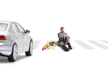 Wall Mural - Businessman hit by a car sitting at pedestrian crossing