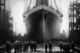 Fototapeta Nowy Jork - black and white vintage photograph of grandeur of Titanic's construction in 1910, with towering cranes surrounding the colossal hull. Workers in period attire diligently toil in dry dock. AI-generated