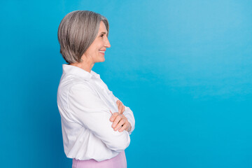 Sticker - Profile photo of elegant cheerful aged person folded arms look empty space isolated on blue color background