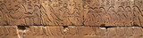 Panoramic picture with Egyptian stone carved showing a burial ceremony 