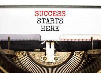 Wall Mural - Success starts here symbol. Concept word Success starts here typed on beautiful retro old typewriter. Beautiful white paper background. Business motivational success starts here concept. Copy space.